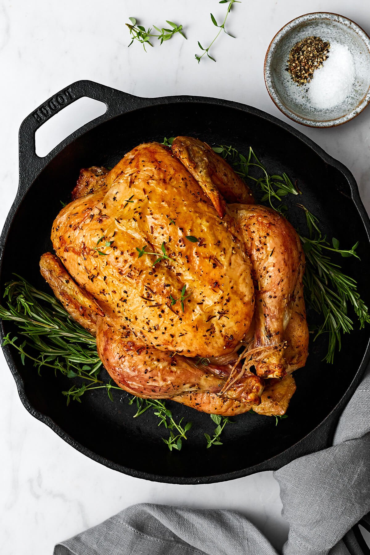 Whole roast chicken in a skillet