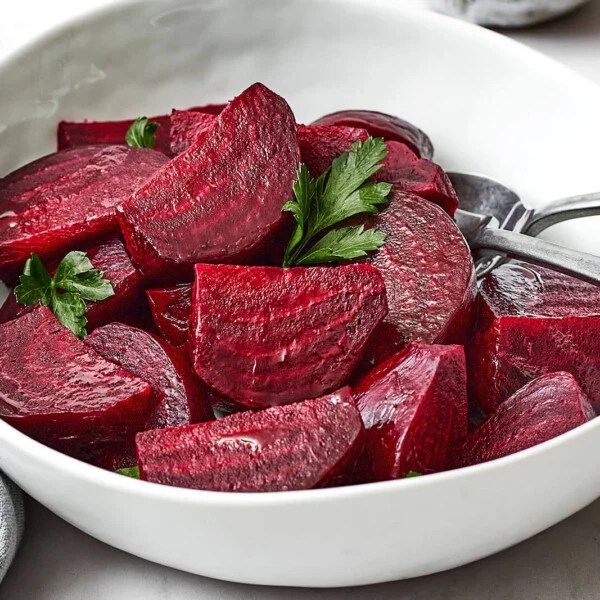 A white bowl of roasted beets