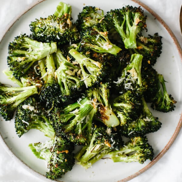 Roasted broccoli on a white plate.
