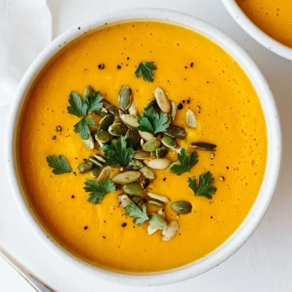 Roasted Butternut squash soup in a bowl with toppings.