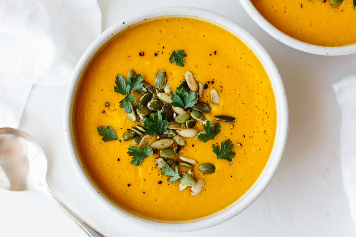 Roasted Butternut squash soup in a bowl with toppings.