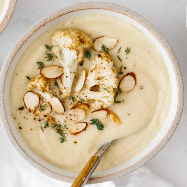 Roasted Cauliflower soup in a bowl with spoon.