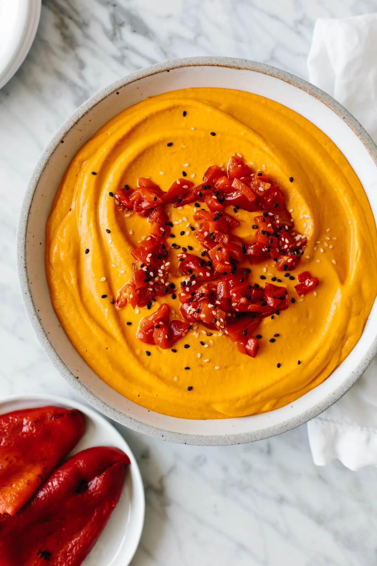A bowl of roasted red pepper hummus.