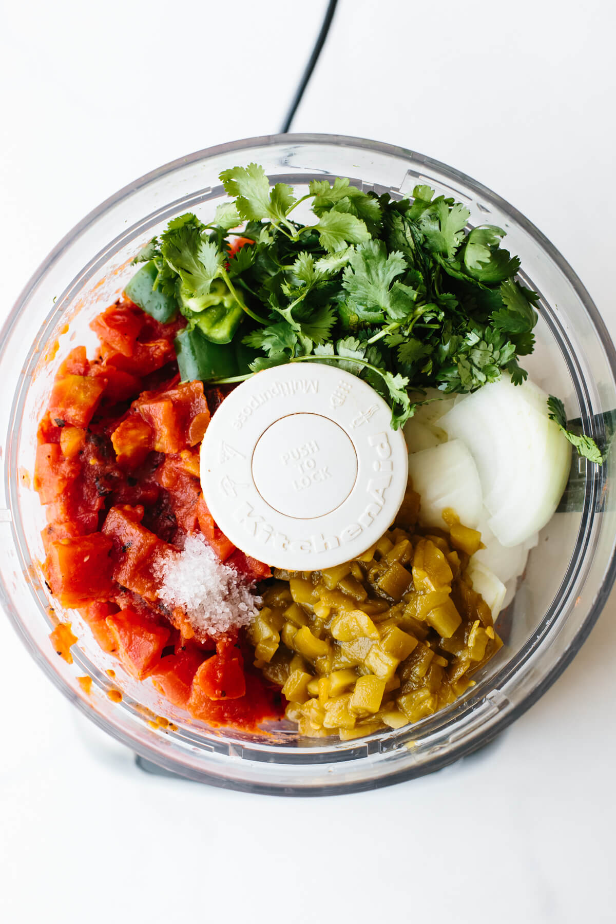 Salsa ingredients in a food processor.