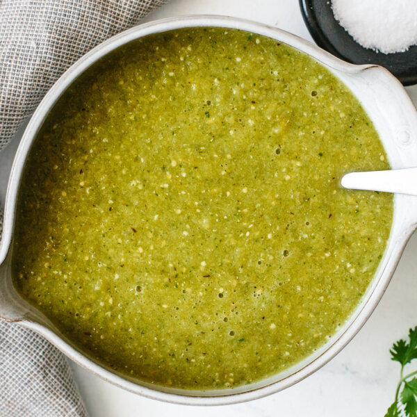 A bowl of salsa verde with a spoon