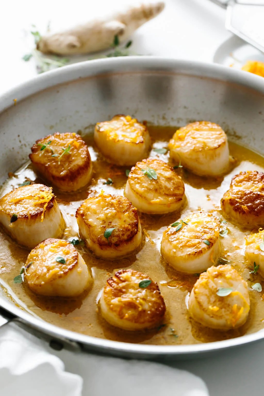 Several scallops in a pan.