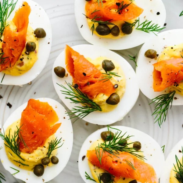 Smoked salmon deviled eggs filled on a plate.