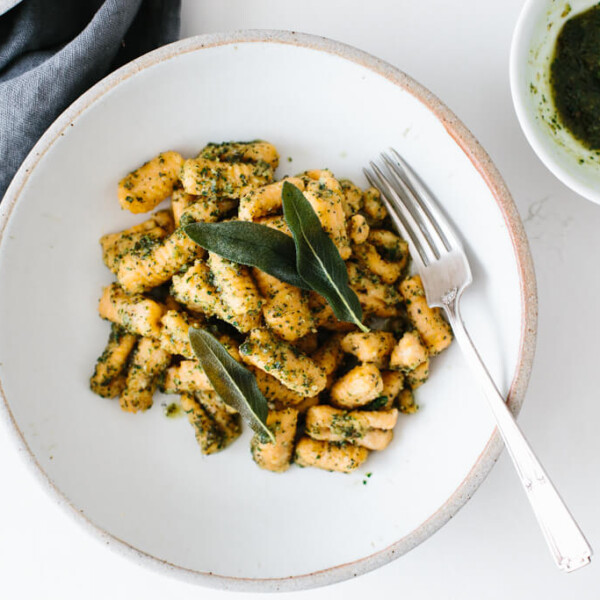 (gluten-free, paleo) Sweet potato gnocchi topped with a delicious sage walnut pesto. It's the perfect hearty and savory meal for fall and winter.
