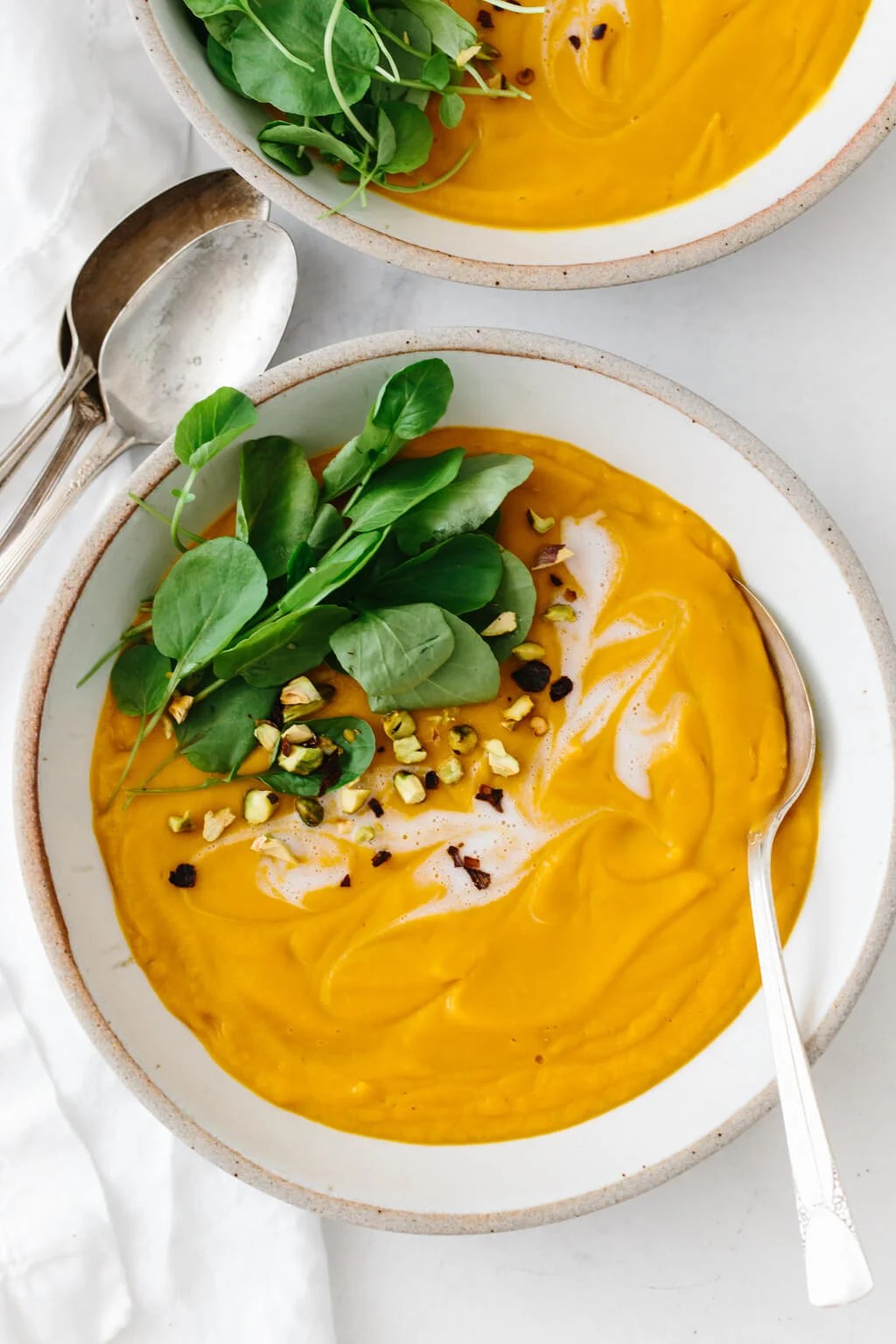 Sweet potato soup topped with watercress and coconut cream.