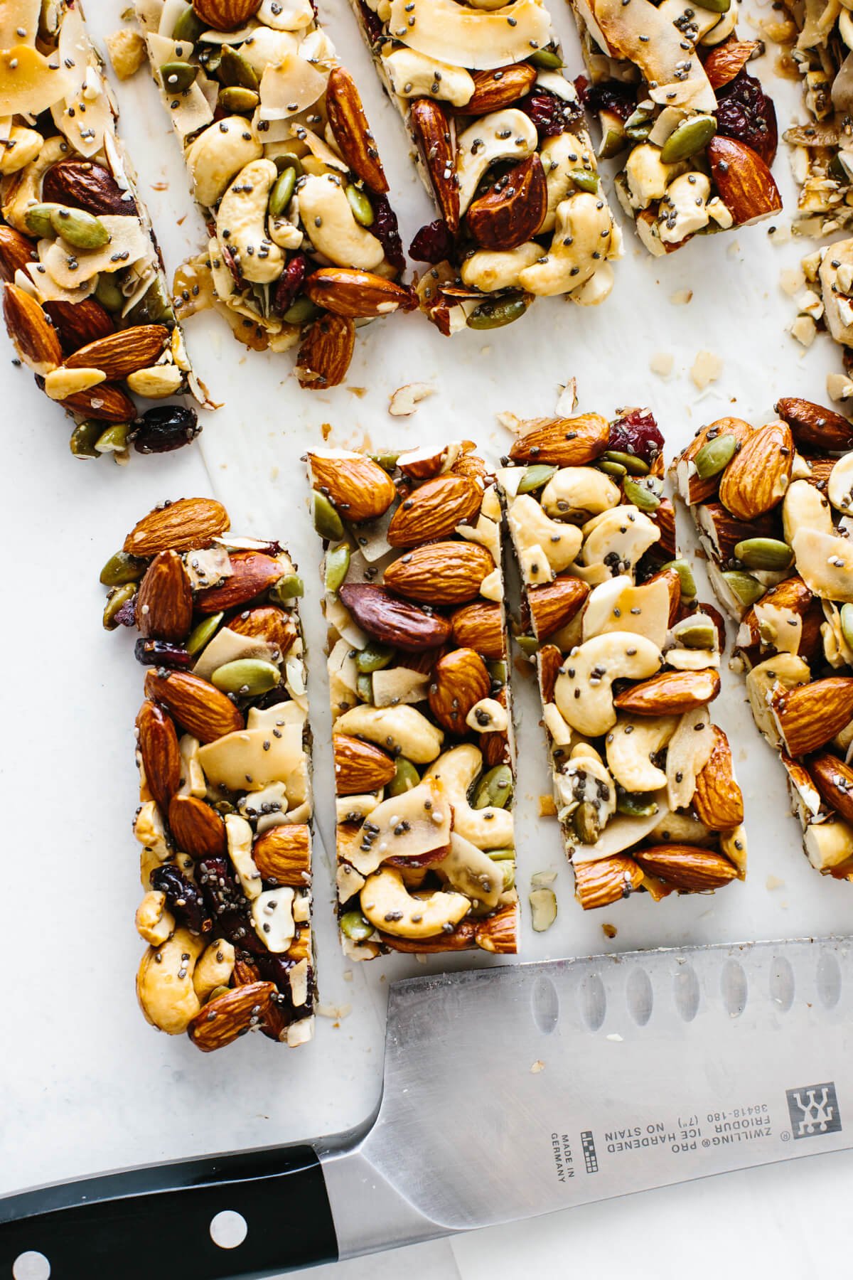 Trail mix bars cut into individual bars next to a knife.