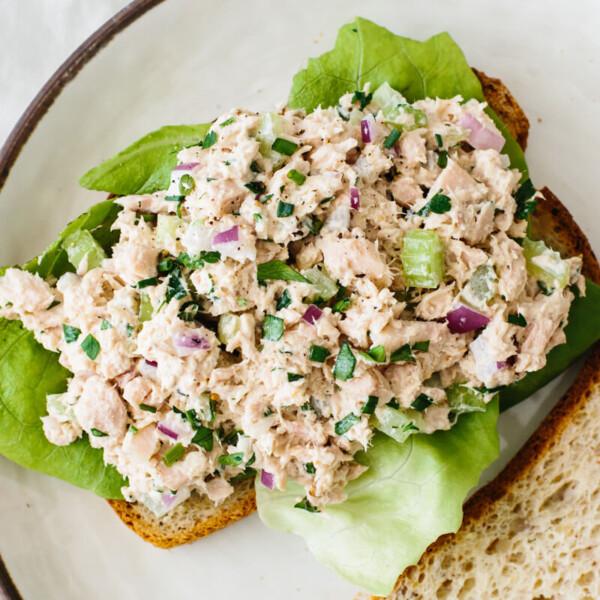 Tuna salad on a slice of bread with lettuce.