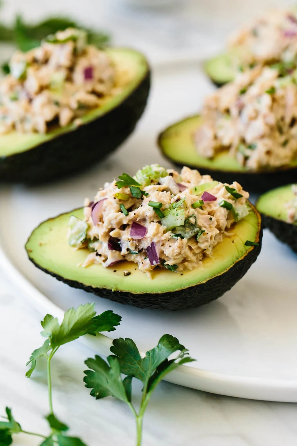 Tuna stuffed avocados are a delicious low-carb, keto, Whole30 and paleo-friendly lunch or snack recipe. A simple combination of tuna salad and avocados makes for a healthy lunch recipe.