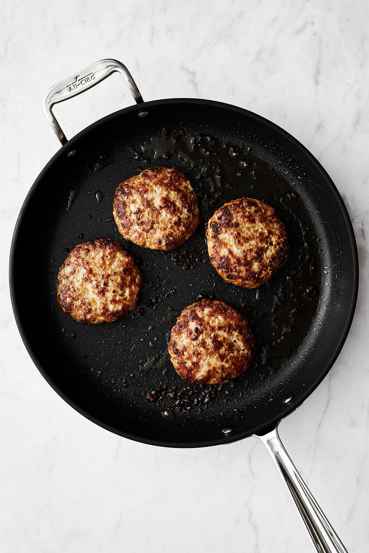 Cooking turkey burgers in a pan