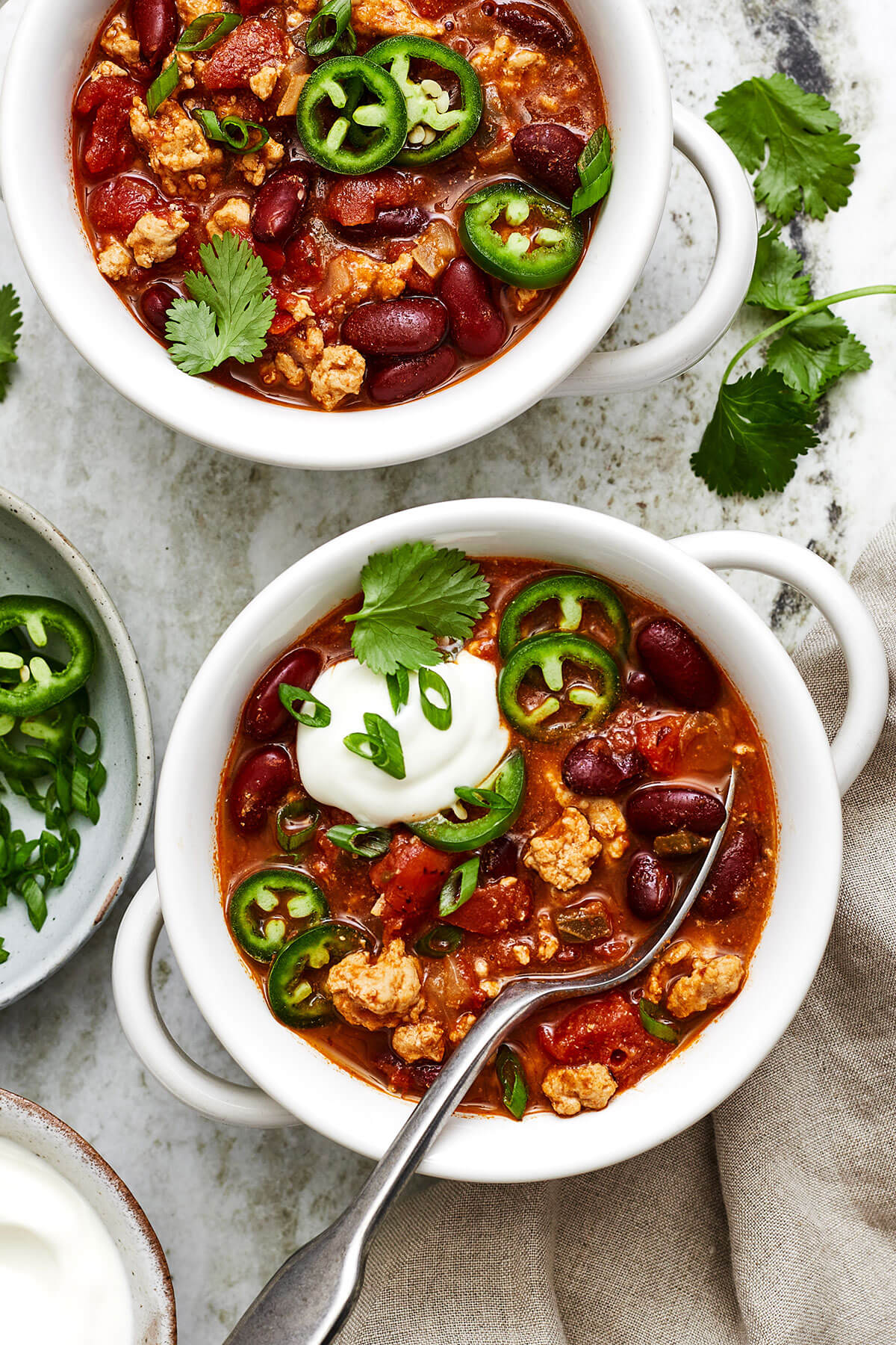 Bowls of turkey chili with a spoon