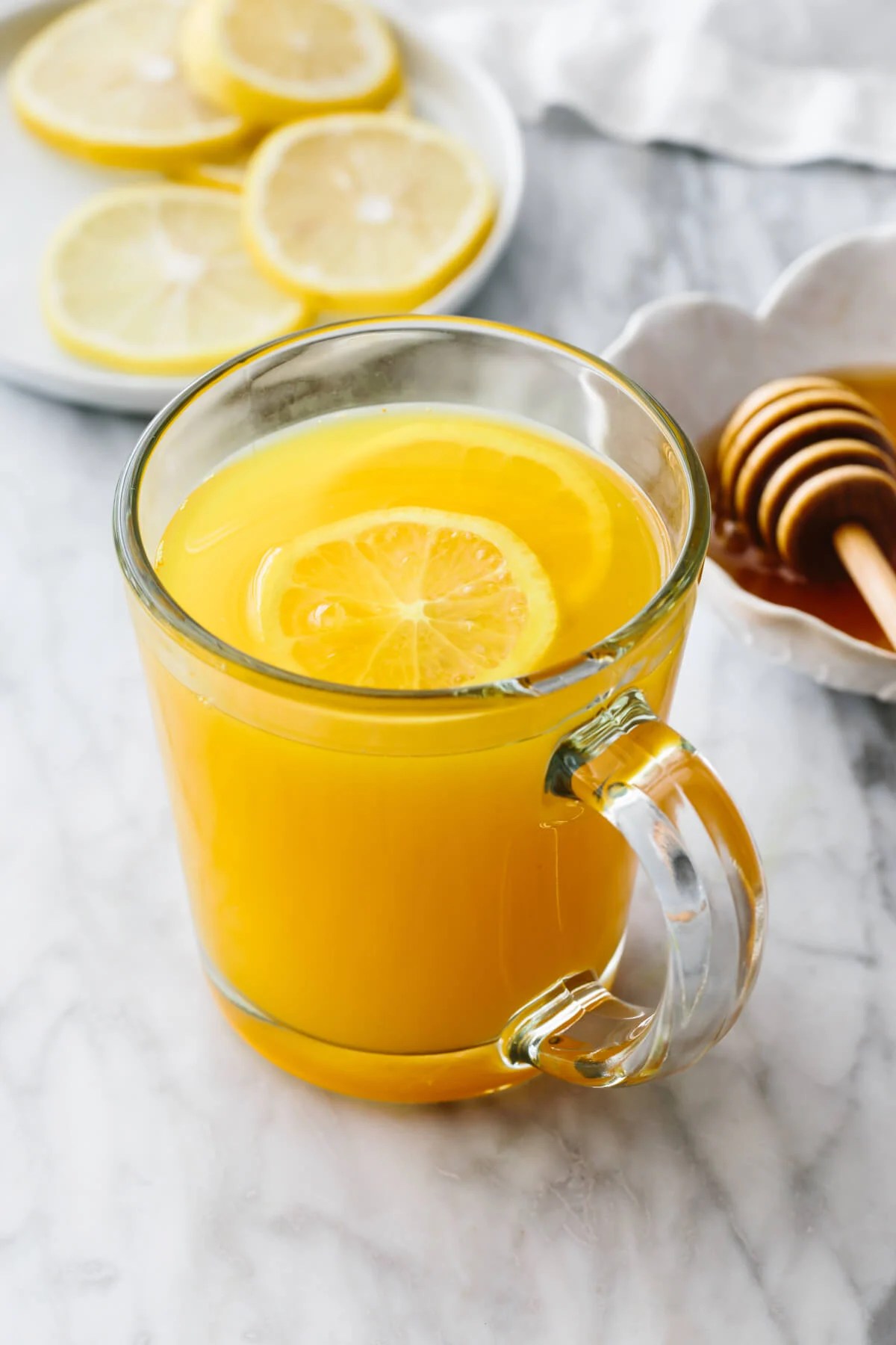 Turmeric tea in a glass with lemon slices.