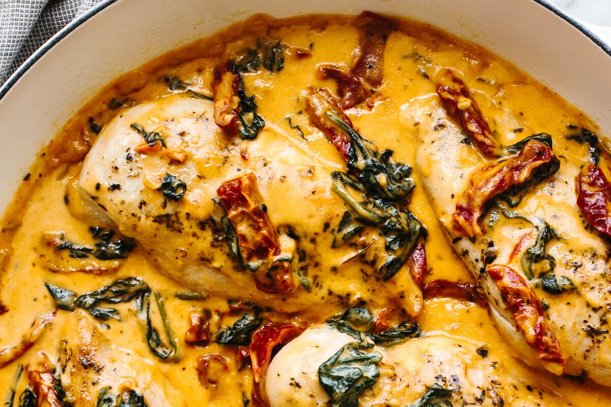 A close of up a skillet with creamy tuscan chicken